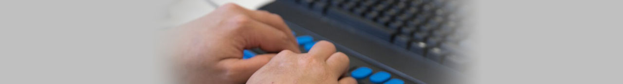Person typing on Braille keyboard