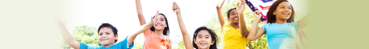 Kids standing outside waving flags